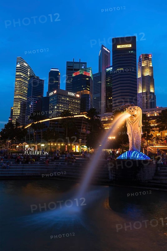 SINGAPORE, JANUARY 1, 2014: Night view of Singapore Merlion at Marina Bay against Singapore skyline. Merlion is a well-known tourist icon, mascot and national personification of Singapore