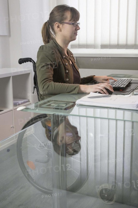 Young woman in a wheelchair at her workplace, Berlin, 18/01/2017
