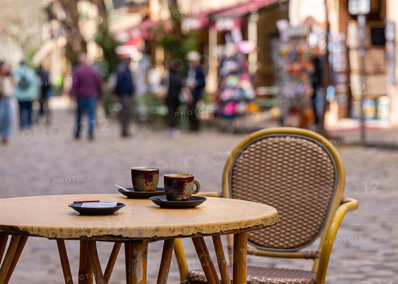 Coffee cups are on a table in a small street cafe, Valdemossa, Balearic Islands, Majorca, Spain