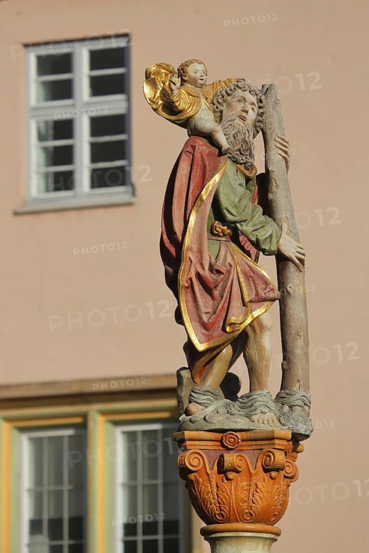 Saint Christopher sculpture and statue by Michel Erhart around 1480, carrying baby Jesus on his shoulder and stick, staff, fountain, Christopherusbrunnen, Weinhof, Ulm, Baden-Württemberg, Germany