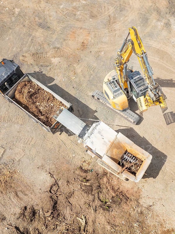Aerial view of an excavator loading soil into a lorry on a construction site, demolition site, recycling, Saarbrücken, Germany