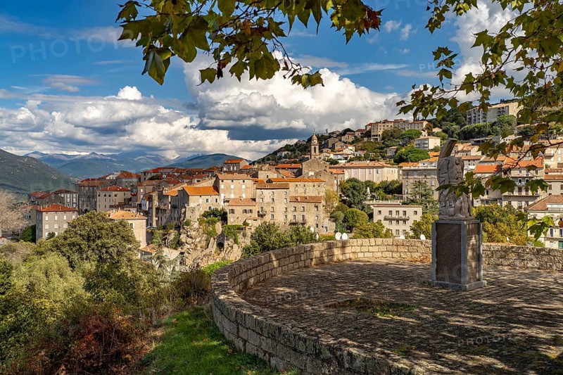 City view with the church of Sainte-Marie and the monument to the resistance movement Monument de la Résistance in Sartene, Corsica, France