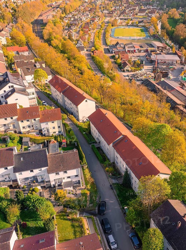 Rooftop view of a residential area with red roofs and trees in autumn, Nagold, district of Calw, Germany