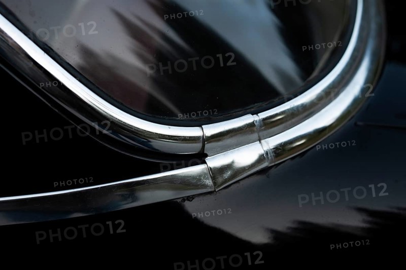 Front window with chrome strips, detail, classic car, black Volvo Amazon, medium class car from Swedish car manufacturer Volvo, built in 1968