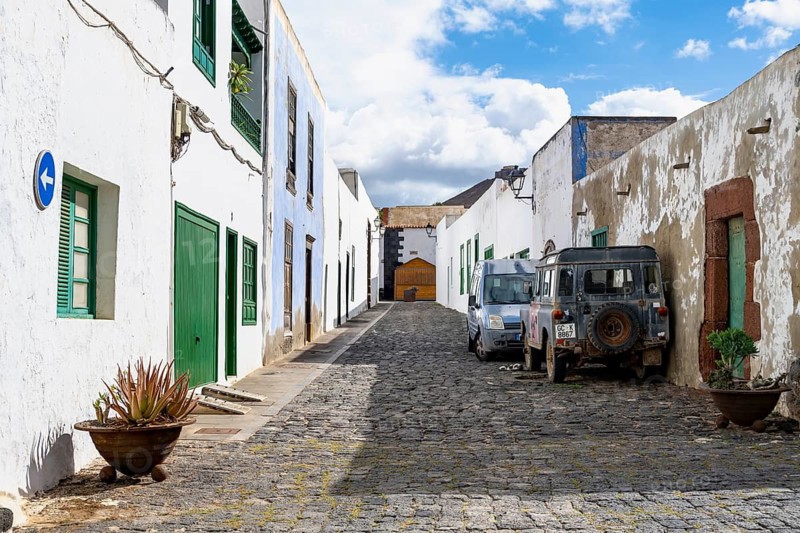 Typical white houses with colored doors and windows in an alley, Teguise, Lanzarote, Canary Islands, Spain