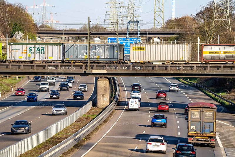 Freight train crosses the A42 motorway at Oberhausen-Zentrum on a railway bridge, the railway line comes from or goes to the OB-Osterfeld marshalling yard, busy cargo train line, North Rhine-Westphalia, Germany