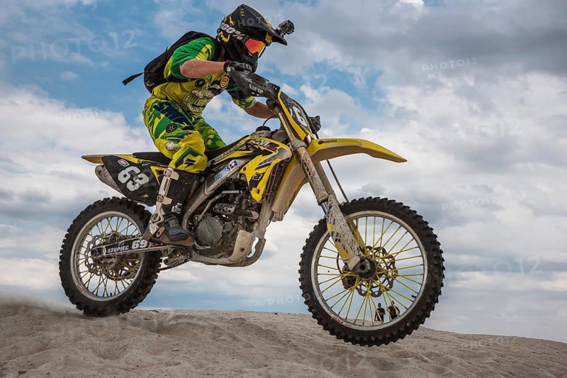 SURMIN, POLAND - JULY 28, 2019: Unidentified motocross rider practises on the sand in a kaolin mine.
