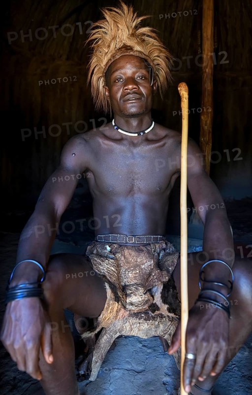Young Himba man in his hut, Ohandungu, Kunene region, Kaokoveld, Namibia