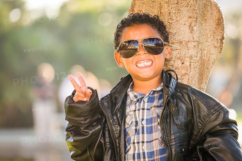 African American and Mexican Boy Dressed Up with Sunglasses and Leather Jacket