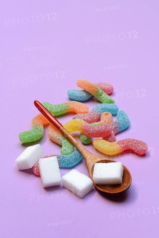 Lots of colorful jelly candies and sugar cubes, sugar consumption