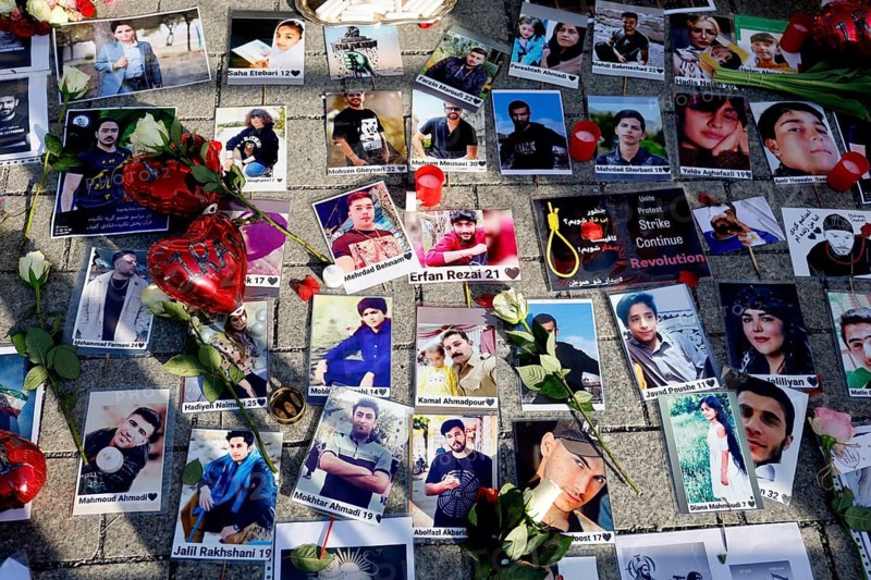 Photos of murdered Iranians who died during the protests in Iran lie during a demonstration against the Iranian regime at the Brandenburg Gate, Berlin, 07.03.2026, Berlin, Berlin, Germany