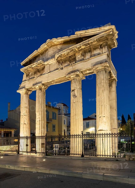 Gate of Athena Archegetis illuminated against the blue night sky, Roman Agora, Athens, Greece