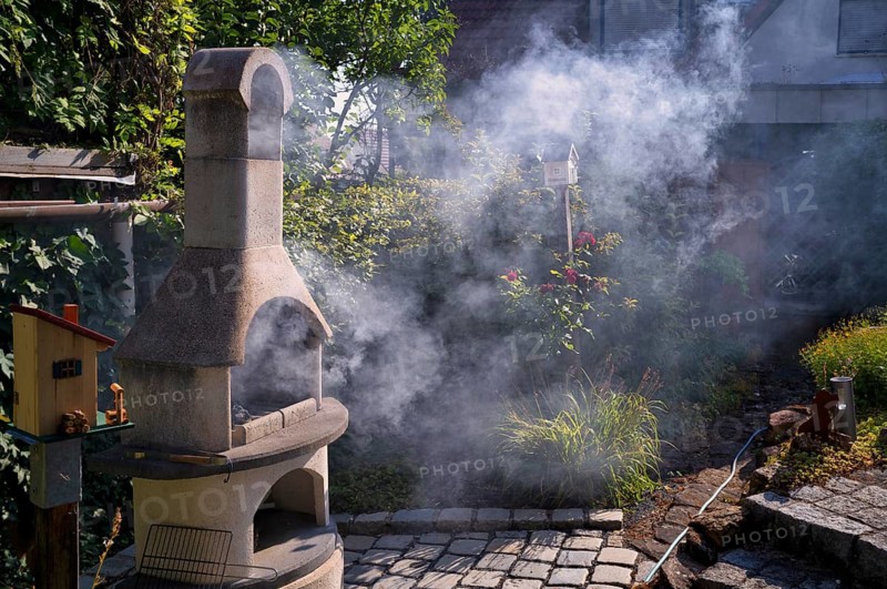 Smoke nuisance, nuisance to neighbours due to smoke, charcoal barbecue, barbecue in the garden, Stuttgart, Baden-Württemberg, Germany