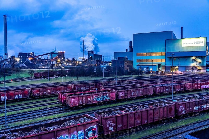 Hüttenwerke Krupp-Mannesmann, HKM in Duisburg, houses of the blast steel plant, coking plant, extinguishing tower with fire cloud, marshalling yard tracks, freight wagon with scrap metal, for melting down, North Rhine-Westphalia, Germany