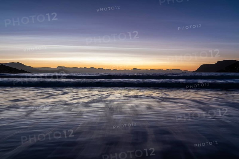 Ocean surf in sandy bay on the Norwegian European Sea at dusk, Söröya, Finnmark, December 2018
