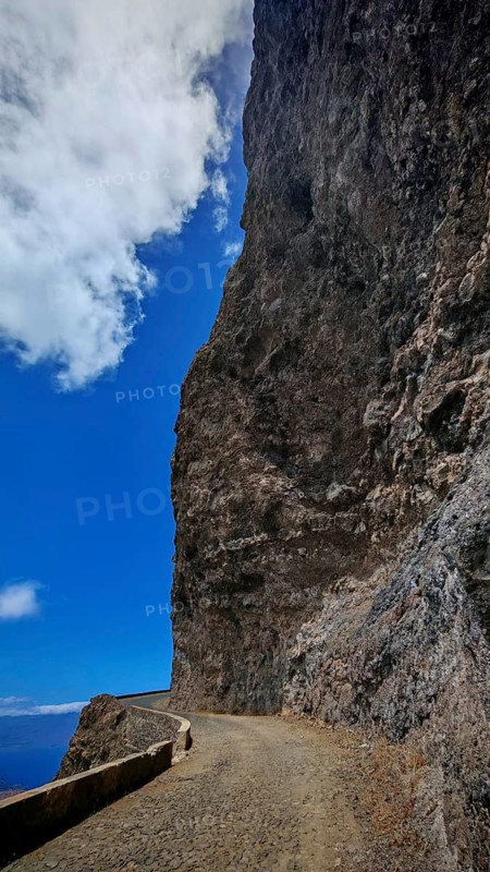 Narrow road along a high rock face under clear blue sky, hiking, Monte Verde, Sao Vicente, Cabo Verde, Cape Verde, Cape Verde