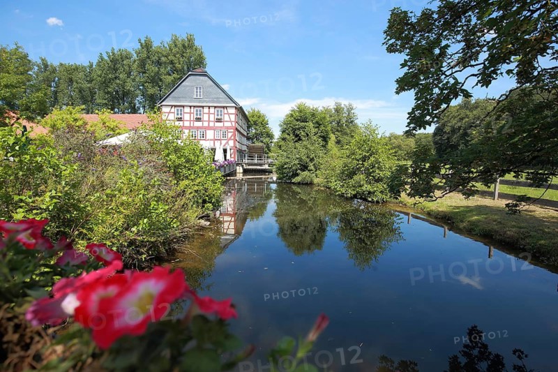 Walkemühle with reflection in the Eder, half-timbered house, Frankenberg, Hesse, Germany