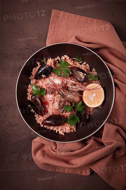 Seafood paella, shrimp and mussels risotto, rice, homemade, top view, no people