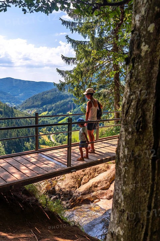 Mother with her son on a bridge at the Todtnau waterfall in the Black Forest in Germany