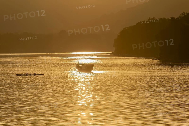 Sunset on the Mekong with excursion boats, near Luang Prabang, Laos