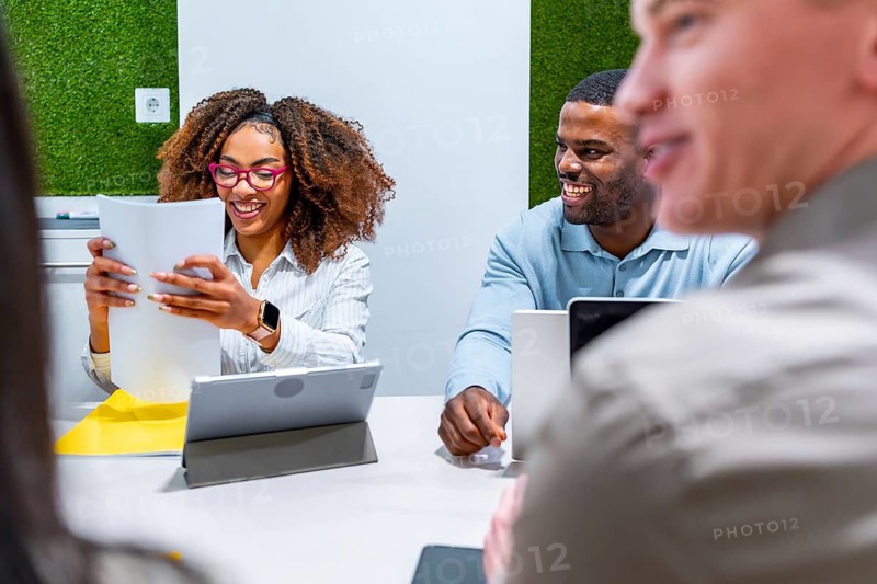 Business people collaborating on a project, sharing ideas and working together in a modern coworking office