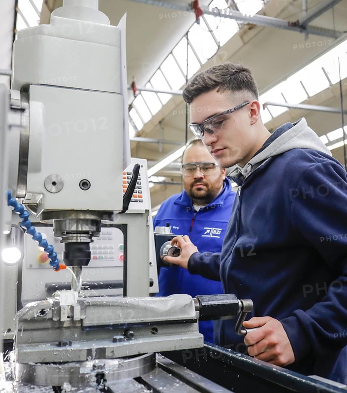 Remscheid, North Rhine-Westphalia, Germany - Trainees in metal professions, here with trainer at a machine tool, Vocational Training Centre of the Remscheid metal and electrical industry. - FOR EDITORIAL USE ONLY!