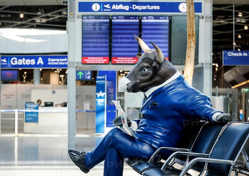 Bull figure with face mask in deserted departure hall at Düsseldorf Airport in times of the corona pandemic, Düsseldorf, North Rhine-Westphalia, Germany