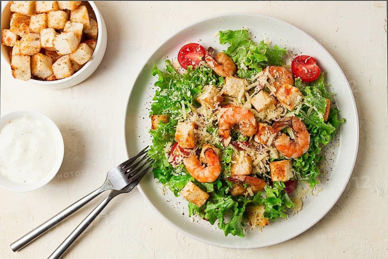 Caesar salad, with shrimp, on a white background, homemade, no people