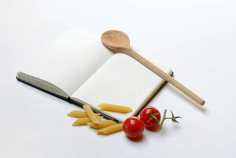 Notebook for recipes, cooking spoons, pasta and tomatoes