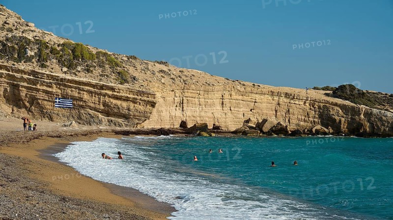 Beach with bathers next to rocky coast and clear blue water under a sunny sky, Cape Fourni, Fourni Beach, near Monolithos village, Rhodes, Dodecanese, Greek Islands, Greece