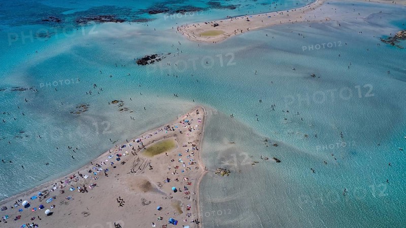 Overtourism, aerial view of a beach with many people in the clear water and on the sand, Elafonissi, lagoon, south-west tip of Crete, Crete, Greek Islands, Greece