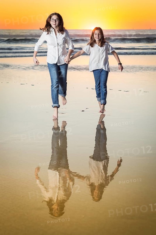 Two Young Sisters Portrait on The Beach