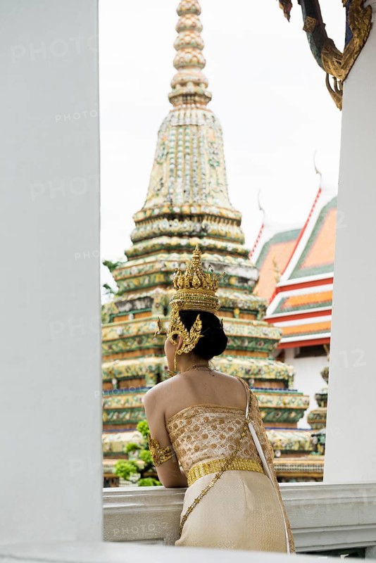 Thai traditionally and festively dressed young woman, Wat Pho, Bangkok, Thailand