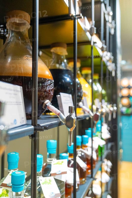 Close-up of glass bottles with different liquids and screw caps on shelves, Sindelfingen, Germany