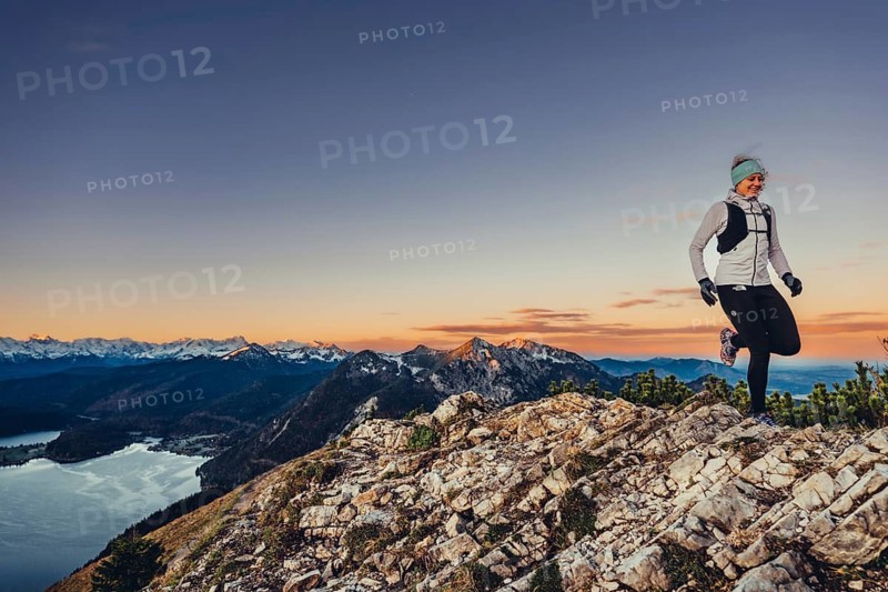Trail running in autumn on the Jochberg on Lake Walchensee against the wonderful backdrop of the Alps, Bavaria, Germany