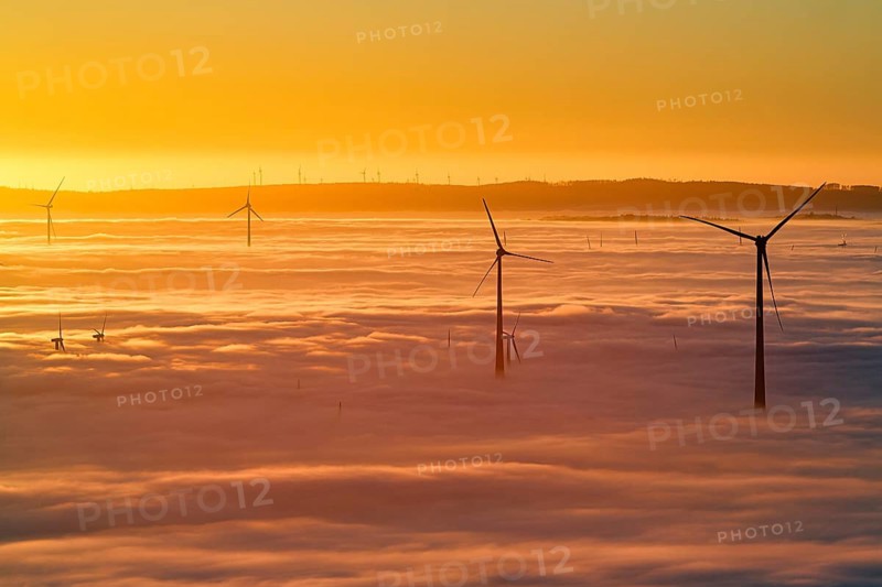 Wind turbines rising from cloud cover, wind farm, silhouettes at sunset, dense sea of fog in the valley, inversion weather, Köterberg, Lügde, Weser Hills, North Rhine-Westphalia, Germany