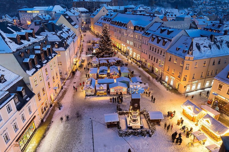 The snow-covered Christmas market seen from the town hall tower, Schneeberg in the Ore Mountains, Saxony, Germany