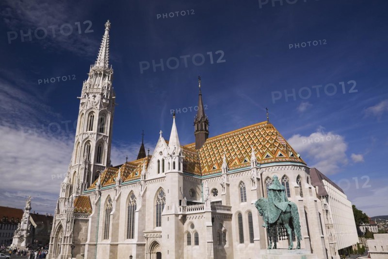 Saint-Mathias church with orange ceramic tiled rooftop and Stephen the 1st statue, Budapest, Hungary