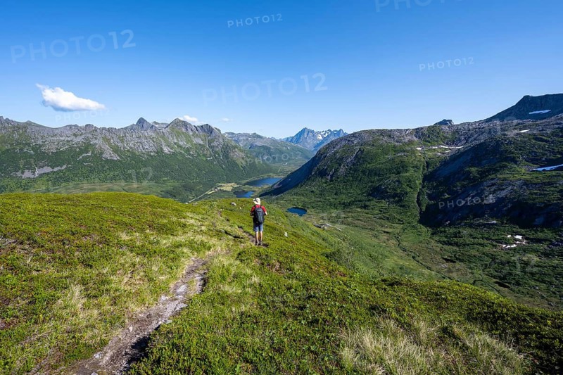 View of mountain landscape, mountaineer on hiking trail to the summit of Rundfjellet, Svolvaer, Nordland, Norway