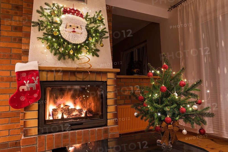 Christmas floral decoration in front of firepace.