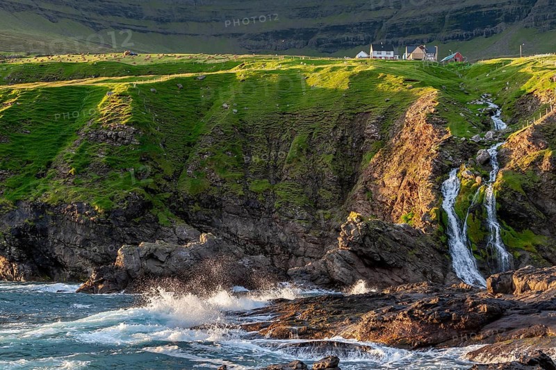 Waves crashing against rocky coast, cliffs with waterfall, houses, Vidareidi, Vidoy Island, Viðareiði, Viðoy Island, Faroe Islands, Denmark