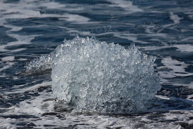 Little icebergs and crushed ice on the black beach at Joekulsarlon glacial lake