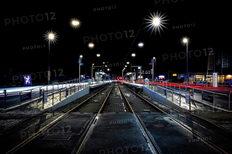 View of a light rail station along the tracks at night, elevated platform, stop, Krepenstasse, Hanover, Lower Saxony Germany