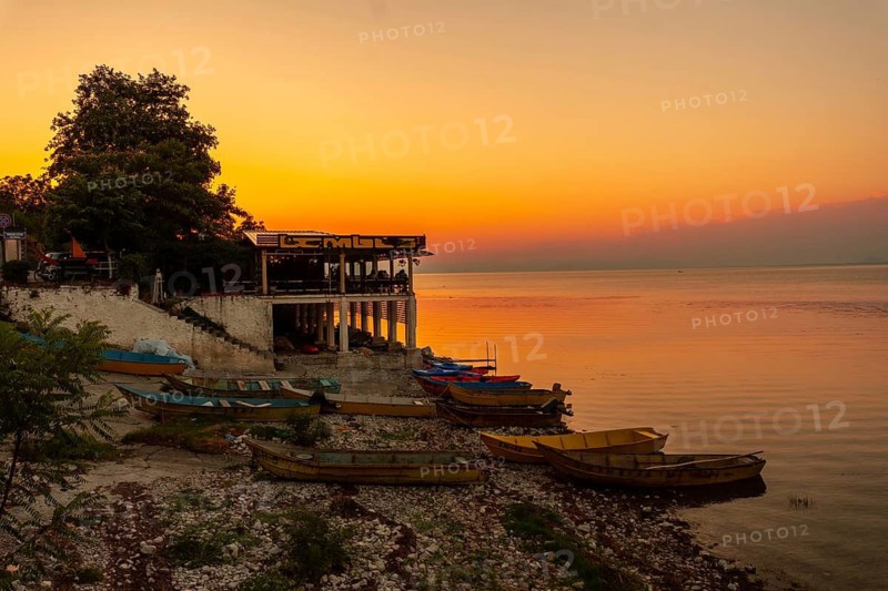 Beautiful orange summer sunset at Shkoder Lake in Shiroka Municipality. Albania