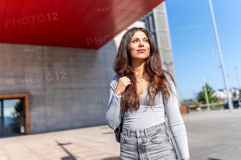 Beauty caucasian casual woman enjoying walking along the city under the sun