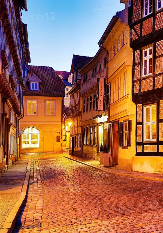 Half-timbered houses in a cobbled street, old town centre in the evening, World Heritage City of Quedlinburg, Saxony-Anhalt, Germany