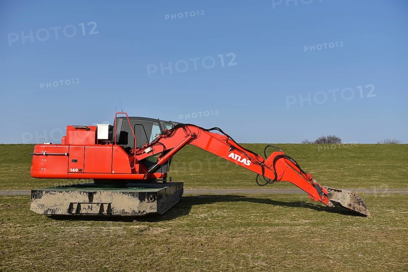 Excavator for dyke processing, coastal protection, Brunsbüttel, Schleswig-Holstein, Germany