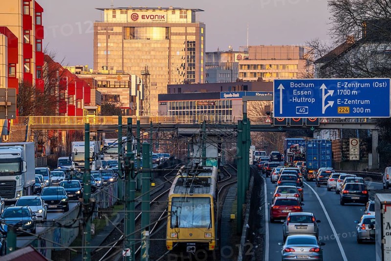 The A40 motorway, Ruhrschnellweg, in the city passage in Essen, light rail line U18, evening traffic jam, EVONIK tower, ETEC office building, North Rhine-Westphalia, Germany