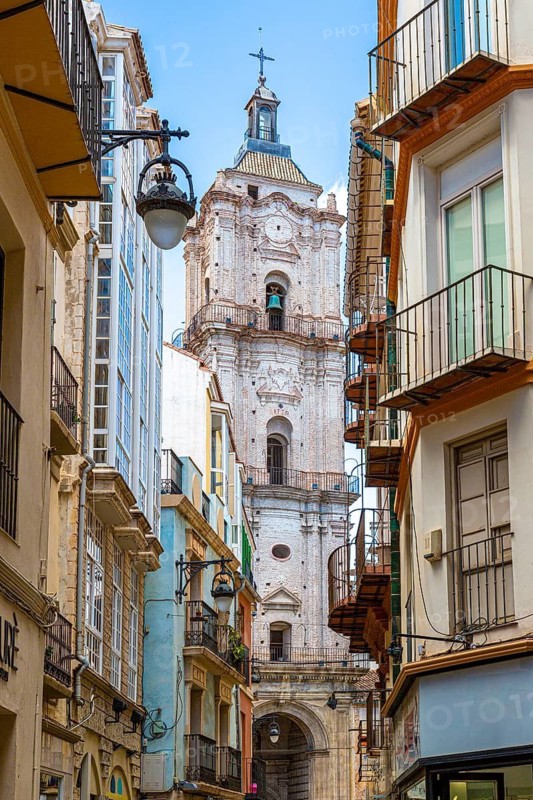 City view with an imposing church tower and neighbouring narrow streets, Malaga, Spain