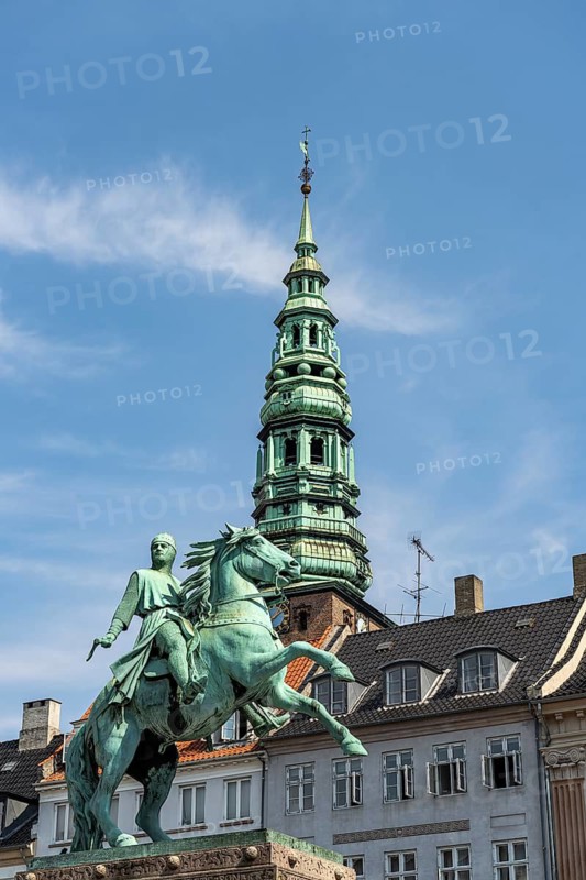 Equestrian statue of Absalon and the tower of St Nicholas Church on the central square Højbro Plads in Copenhagen, Denmark